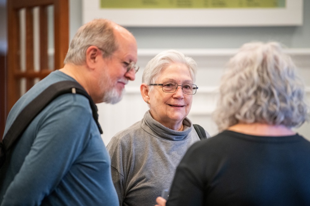 Man and woman smiling at Susan Proctor